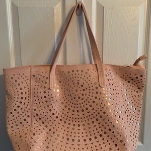 NWT. Cannot tell the brand though.  Light pink and gold under cutouts.